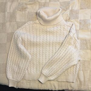 White turtleneck sweater.